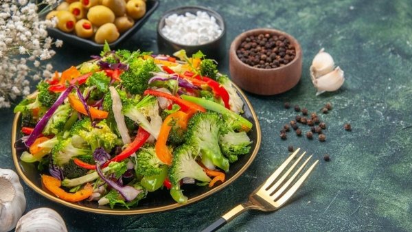 Why can eating raw vegetables cause bloating and flatulence?
