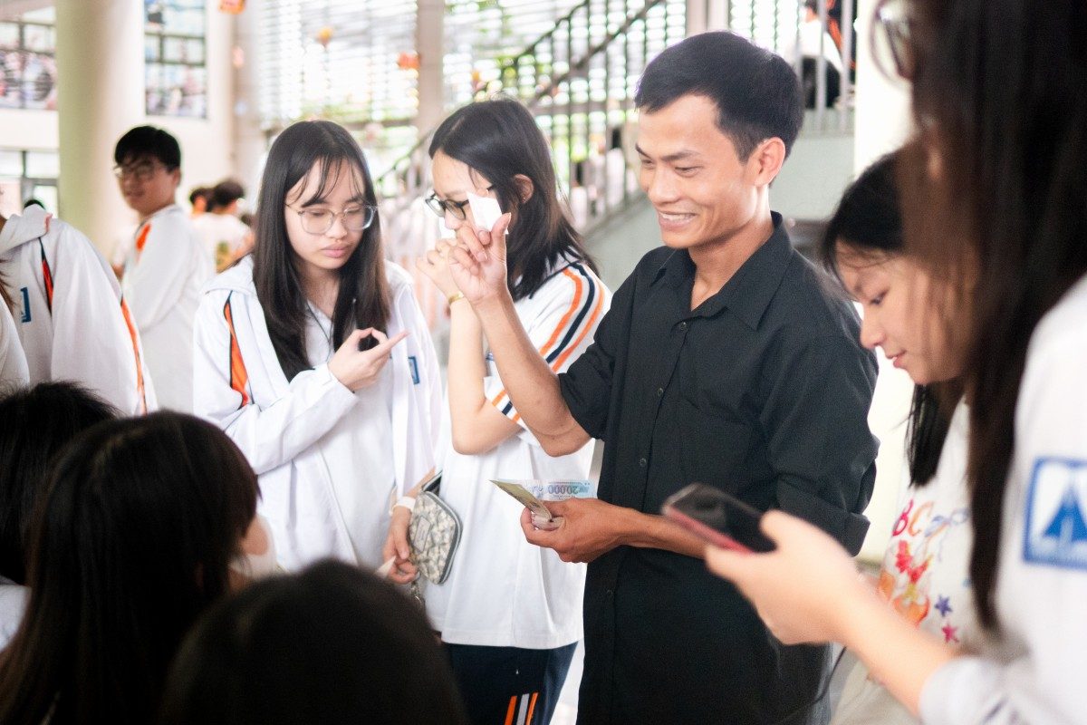 Photos of people bustling around the cake stall.